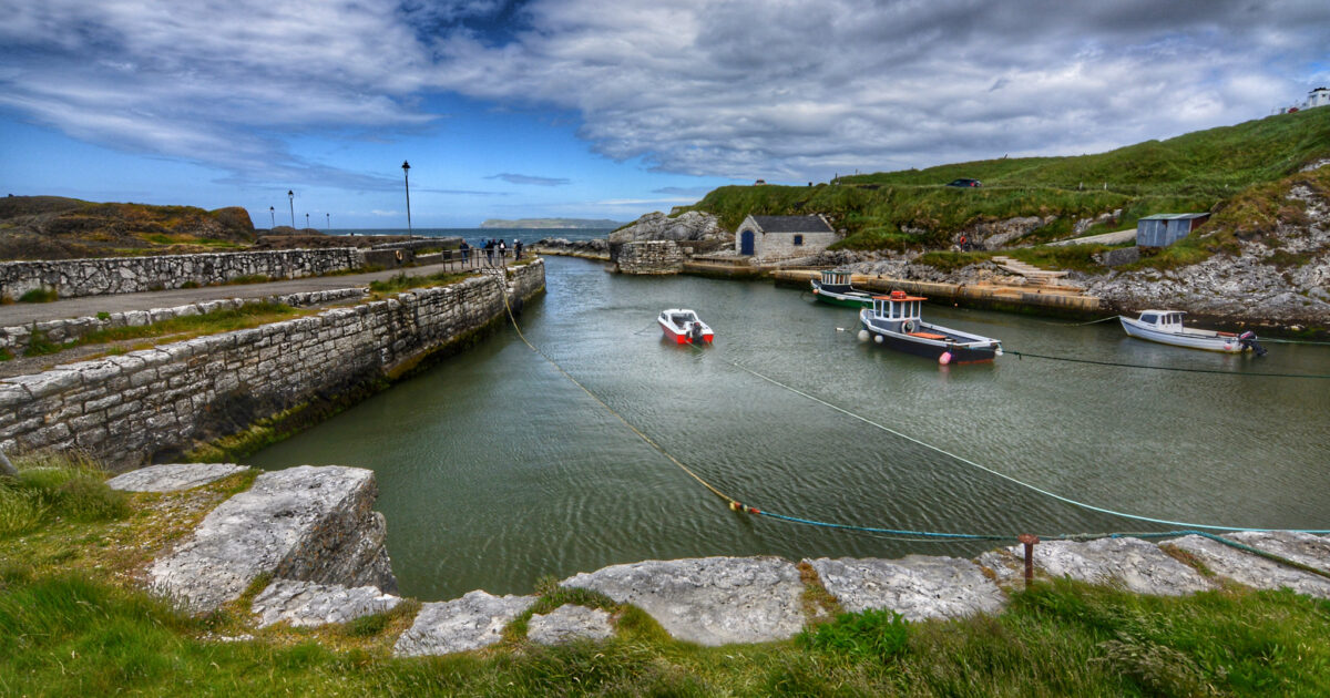 Small boats moored in Ballintoy Harbour, a stone built harbour in Northern Ireland