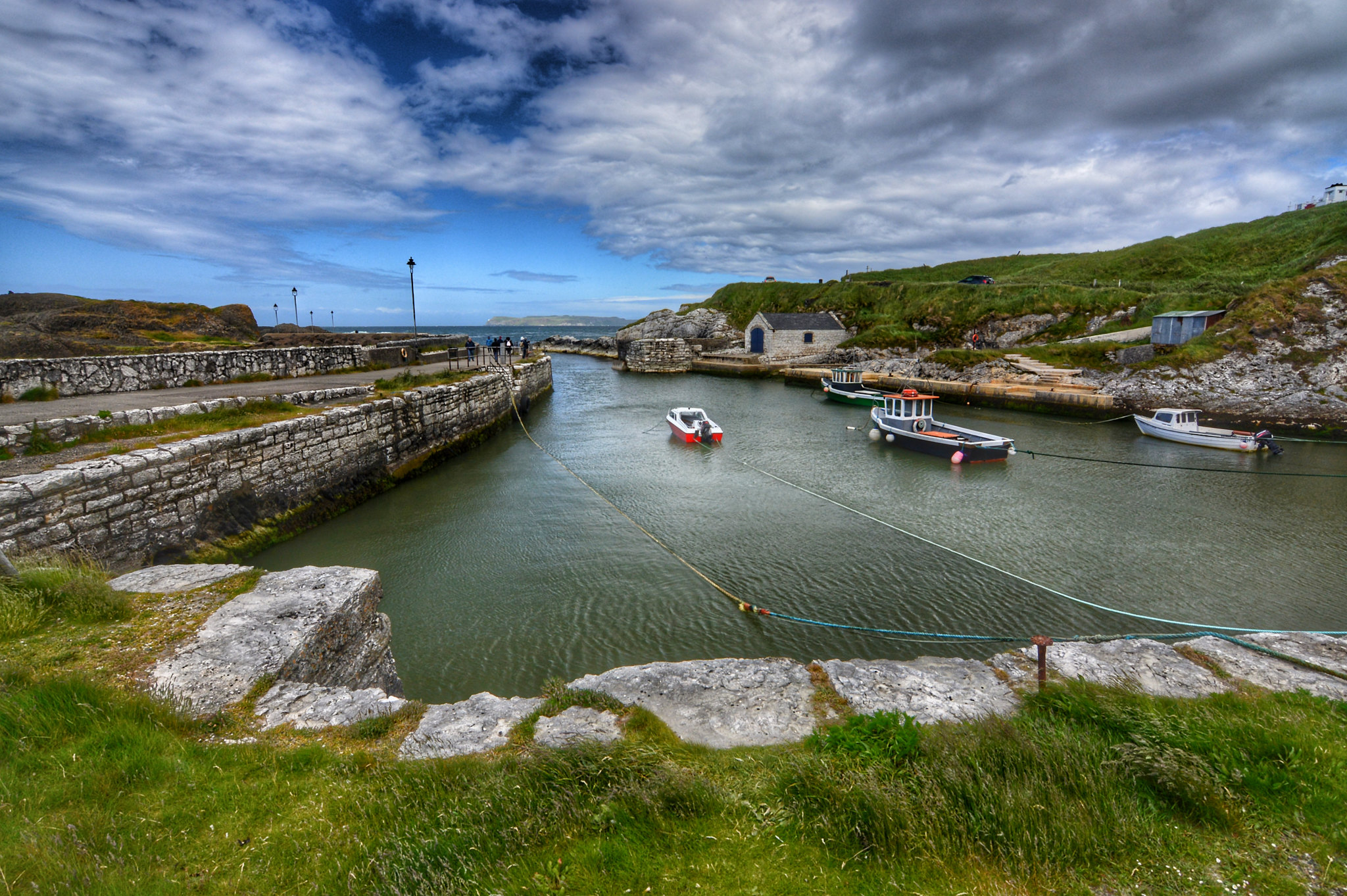 Small boats moored in Ballintoy Harbour, a stone built harbour in Northern Ireland