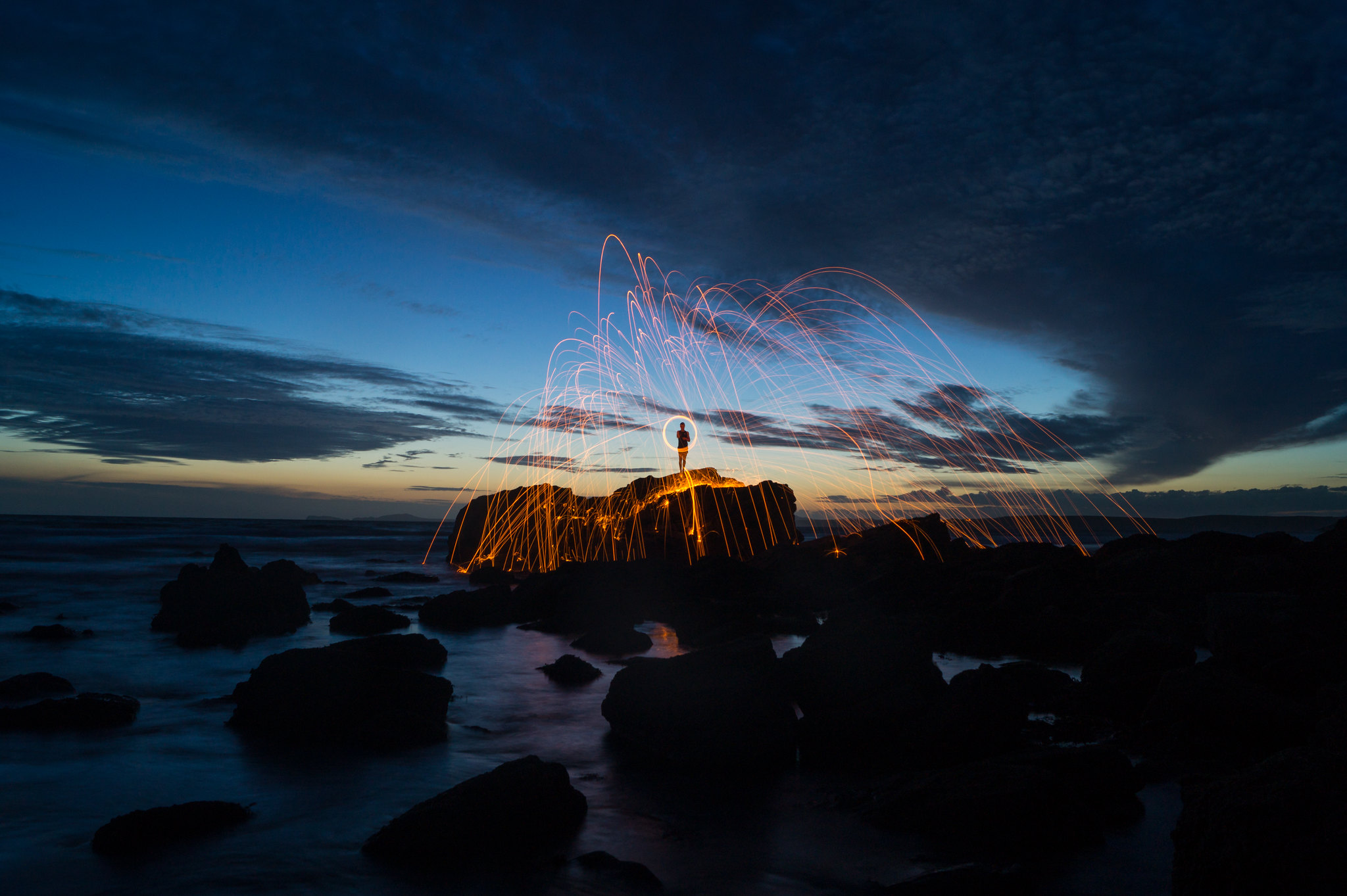 Light art creating patterns against the night sky on the coast of Pembrokeshire in Wales